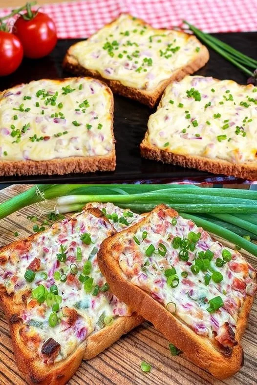 Leckerer Flammkuchen Toast mit frischen Zutaten auf einem Holzbrett.